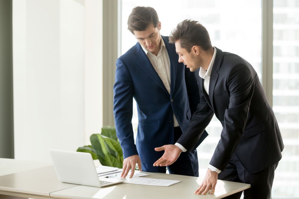 architects-discussing-construction-plan-drawings