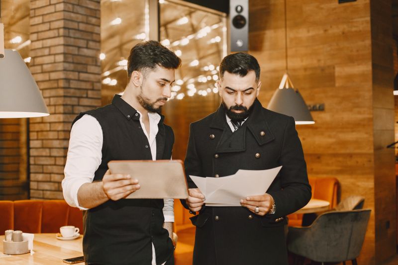 people-stands-looks-documents