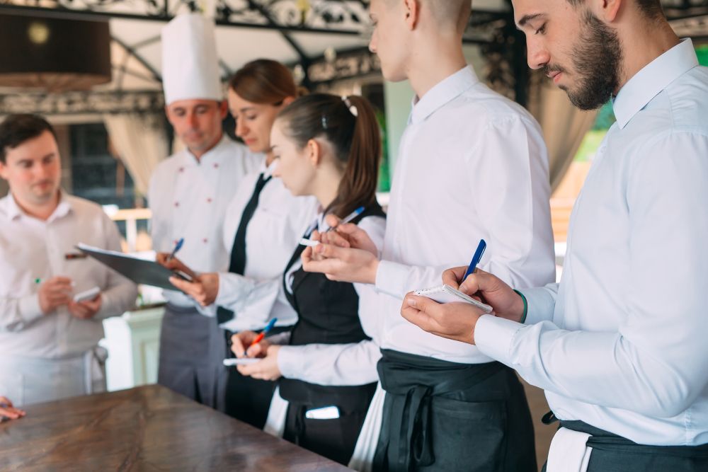 restaurant-manager-his-staff-terrace-interacting-head-chef-restaurant